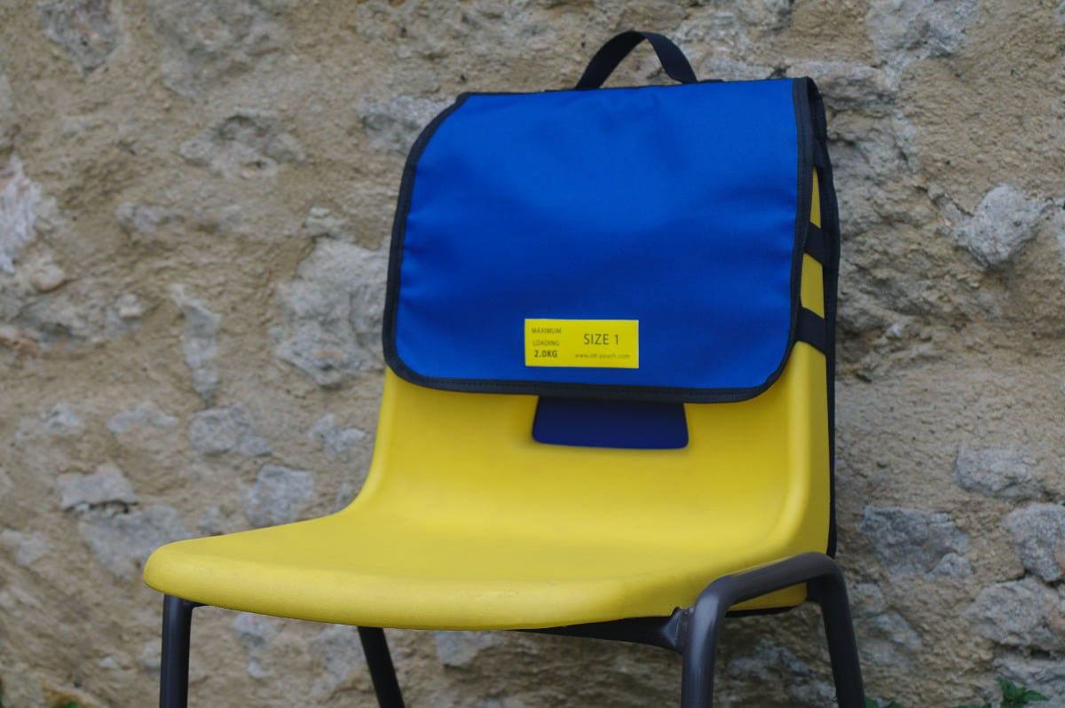 Blue OTT Pouch chair bag attached to school chair-view from the front